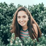 woman standing in bushes