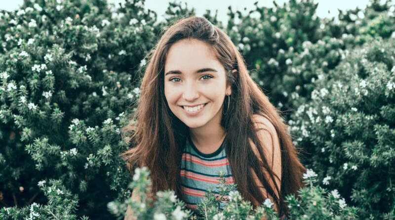 woman standing in bushes